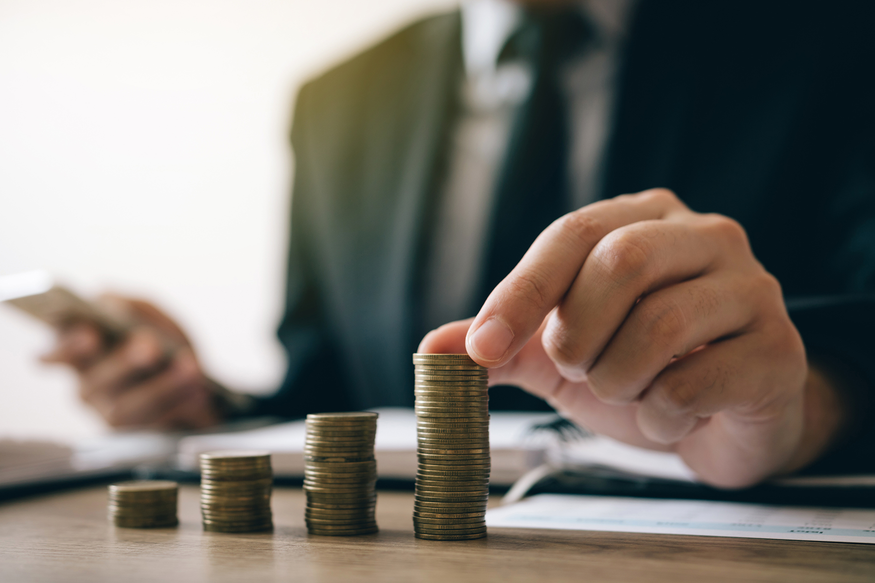 asian investors man are placing coins in a growing 2024 photo