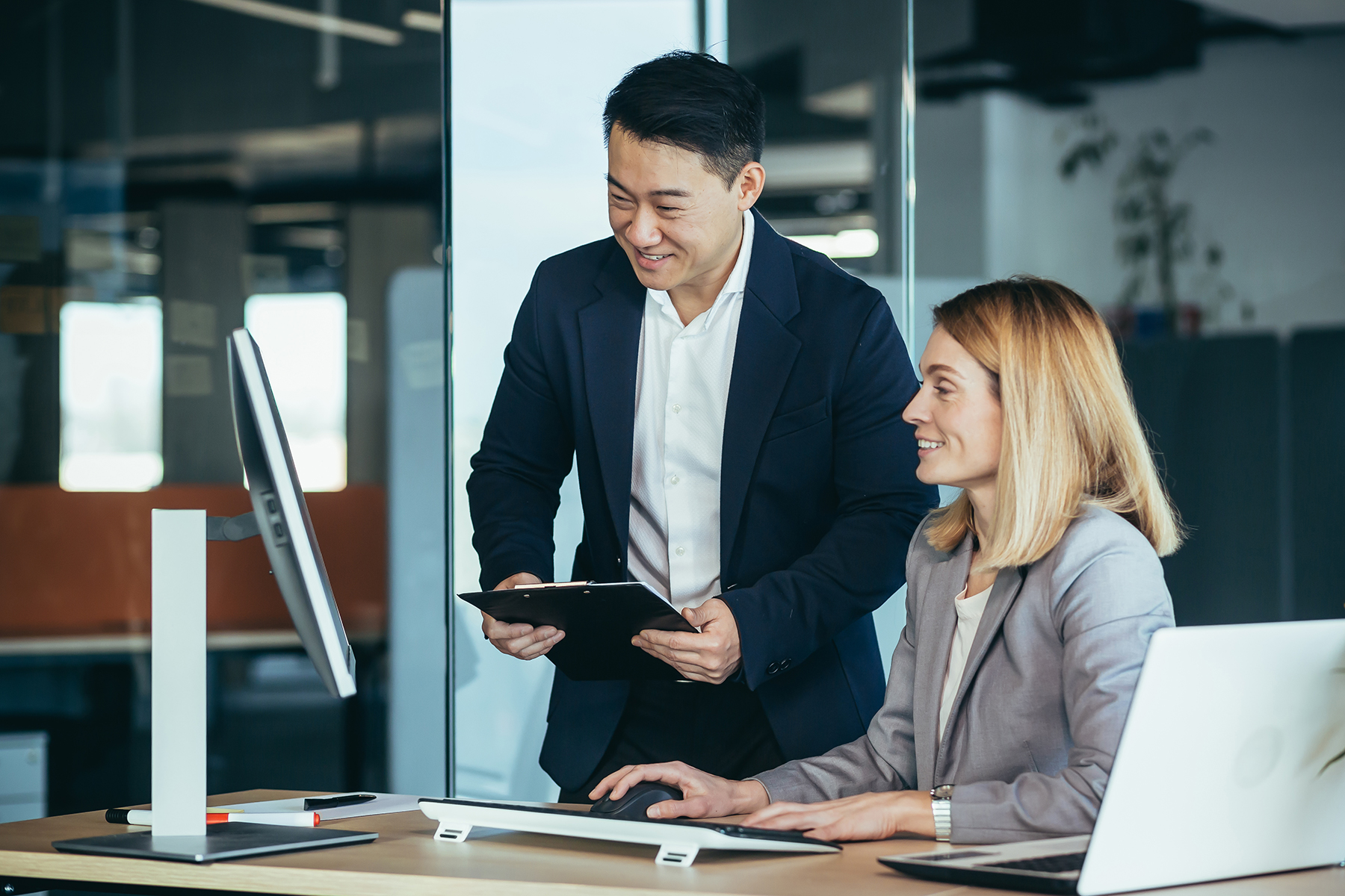 two asian male and female colleagues in a modern photo